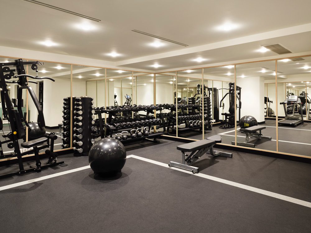 a photo of a gym with equipment that includes elliptical machines and a giant exercise ball.