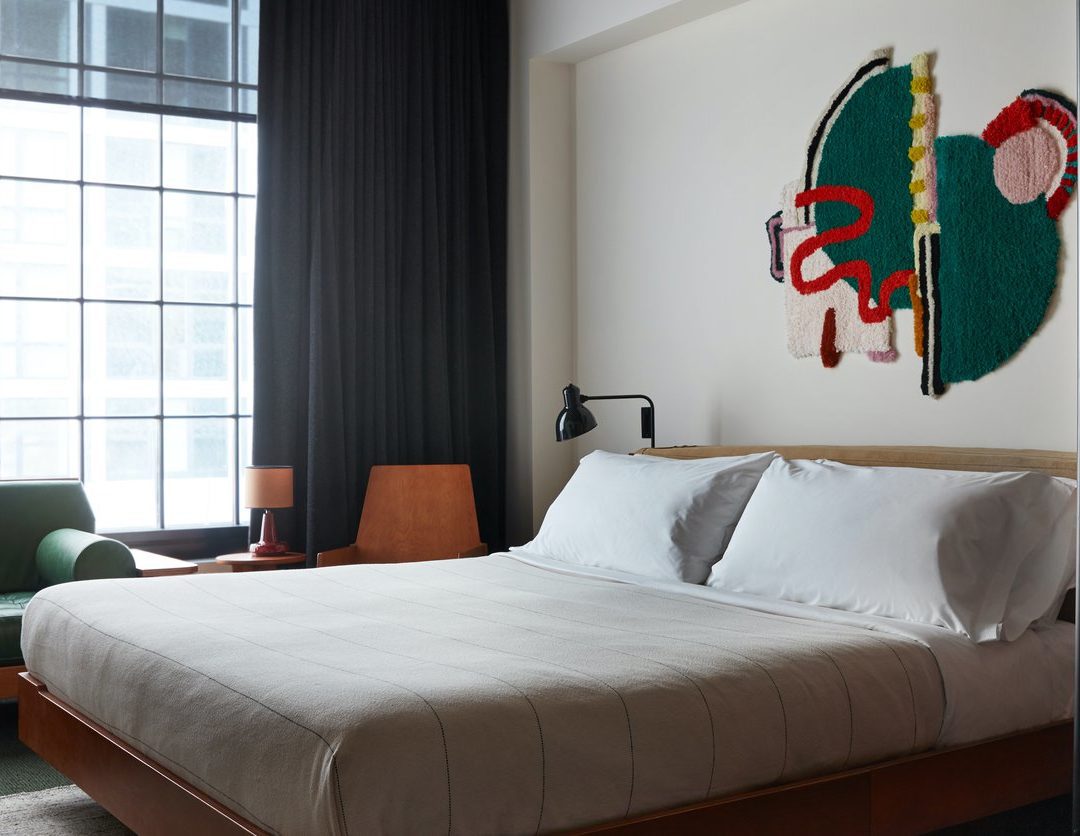 A room with multiple seating options, natural light, and additional lamps