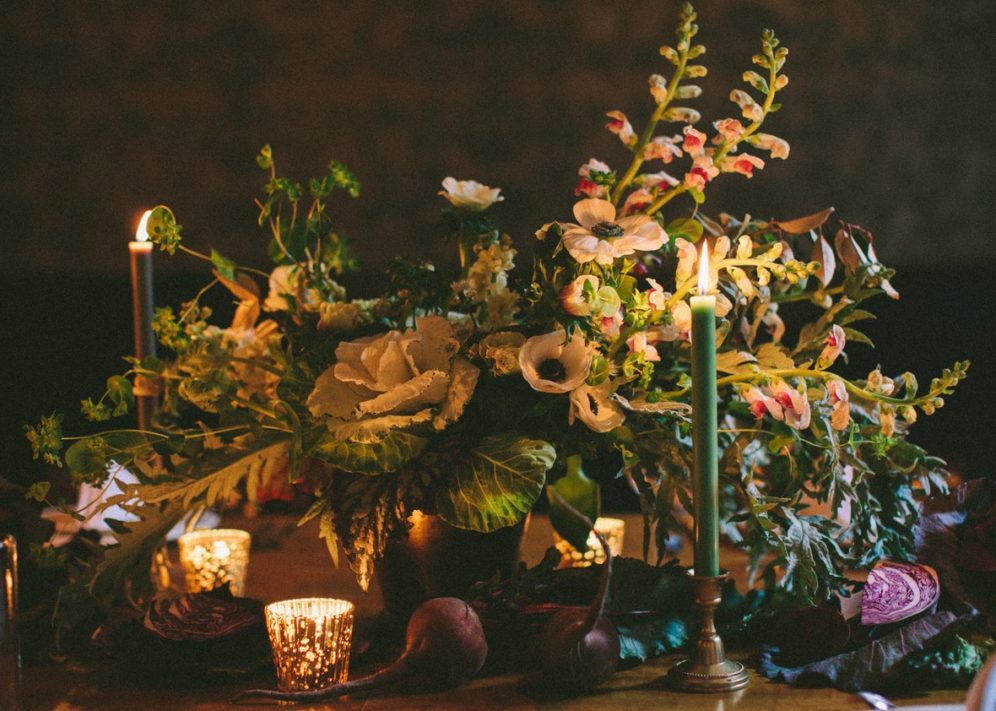 A flower bouquet and candles on the table