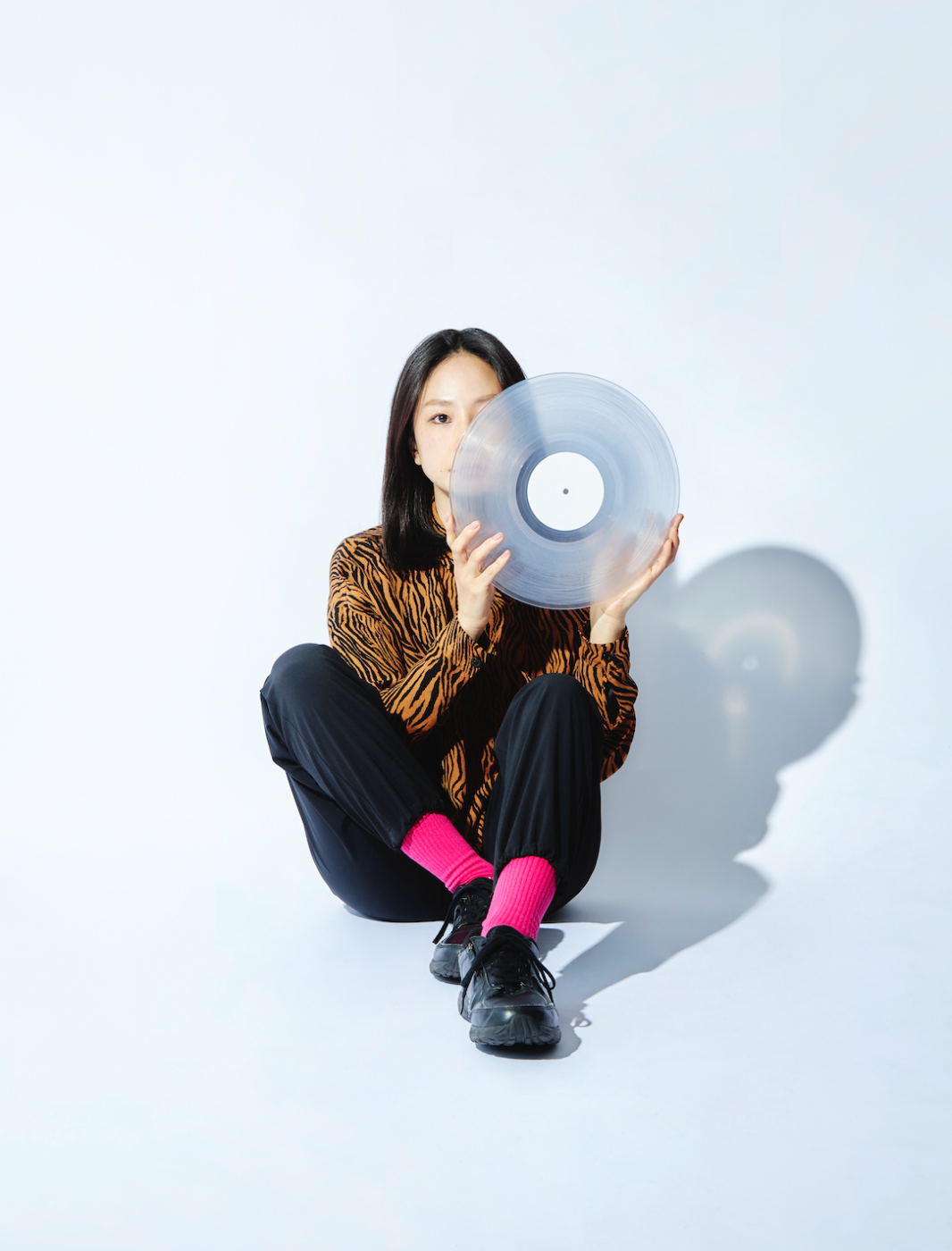 person sitting and holding a semi-transparent record