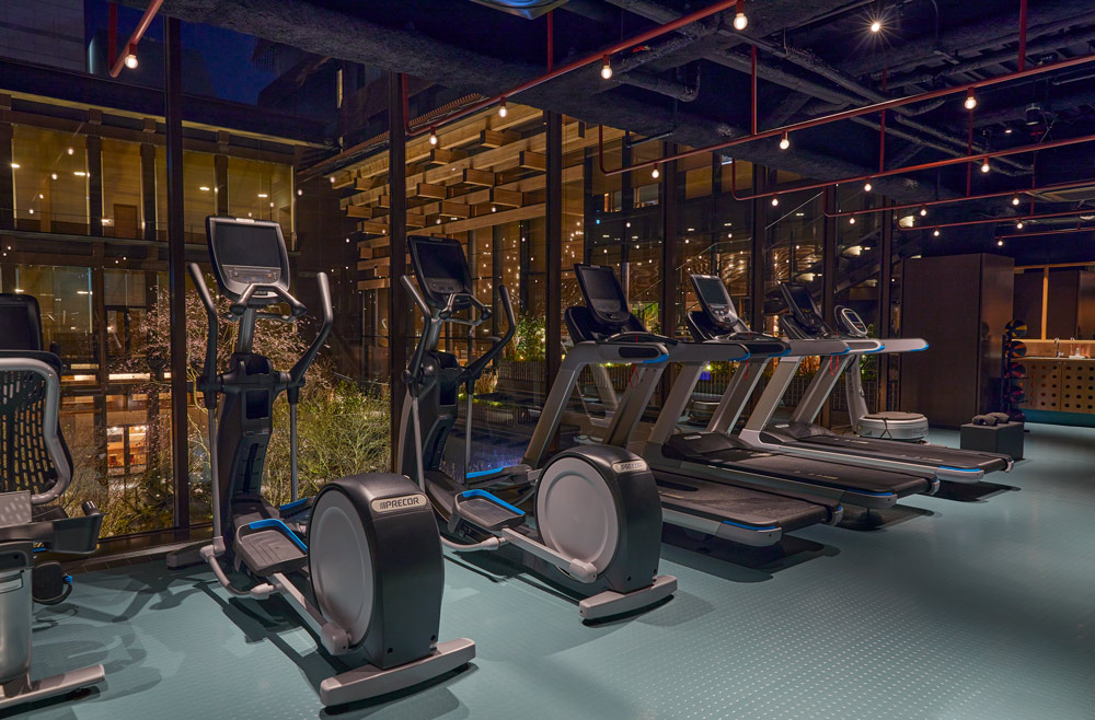 a photo of a gym with equipment that includes treadmills and cross trainer / elliptical trainer machines.
