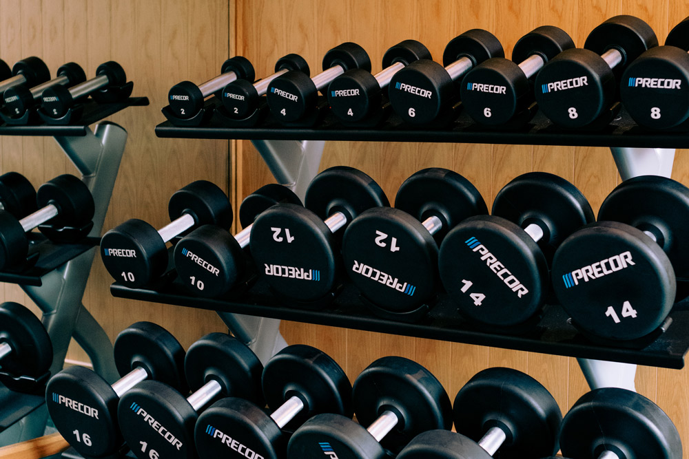 a photo of a gym with equipment that includes free weights