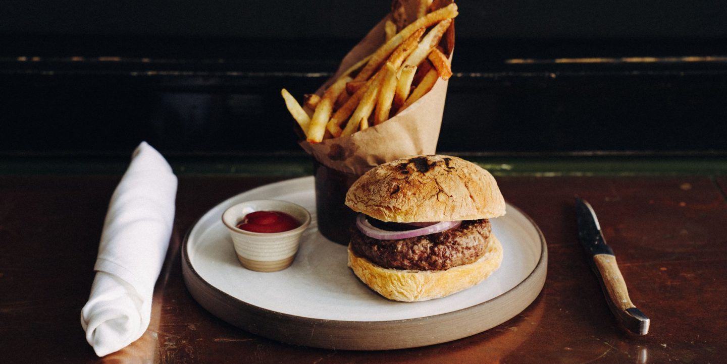 A plated hamburger and fries