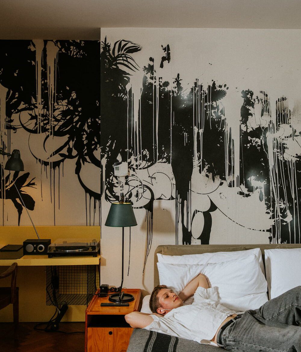 New York - Parking Package. An image of a man relaxing on a bed.