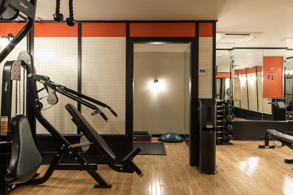 Ace Hotel New York equipment includes free weights, chest press machine, yoga mats, balance dome and exercise bench.