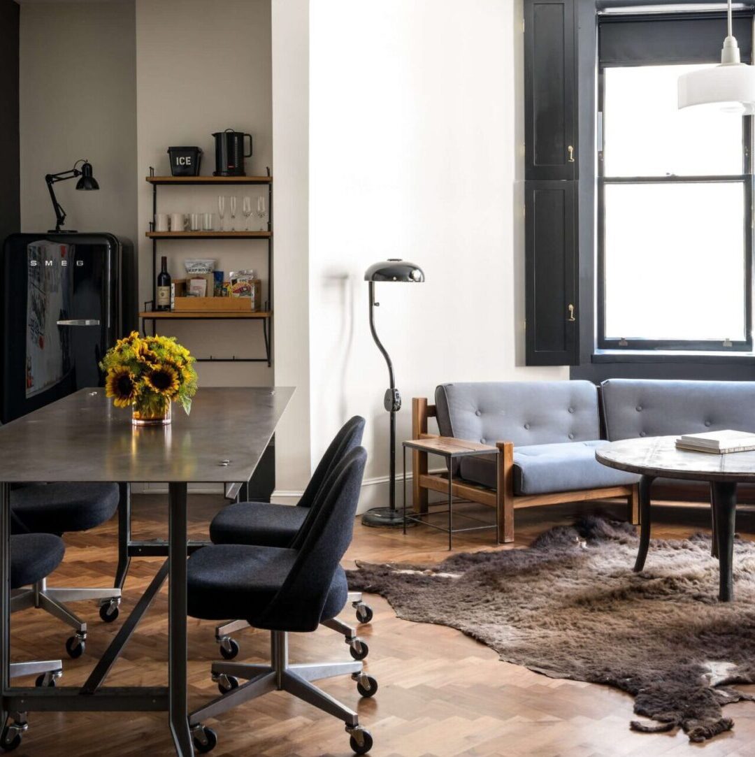 Meeting room with lounge seating and a long work table at Ace Hotel New York