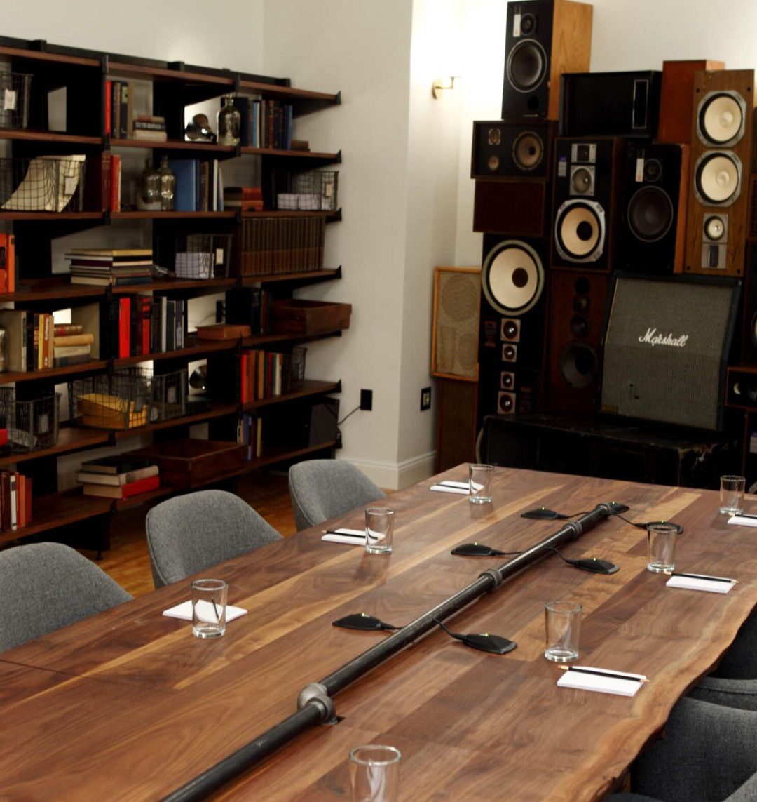 The Boardroom at Ace Hotel New York with walnut conference table and bookshelves