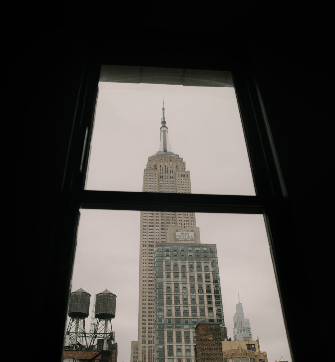 Photoshoot at Ace Hotel New York with a window view of the Empire State Building