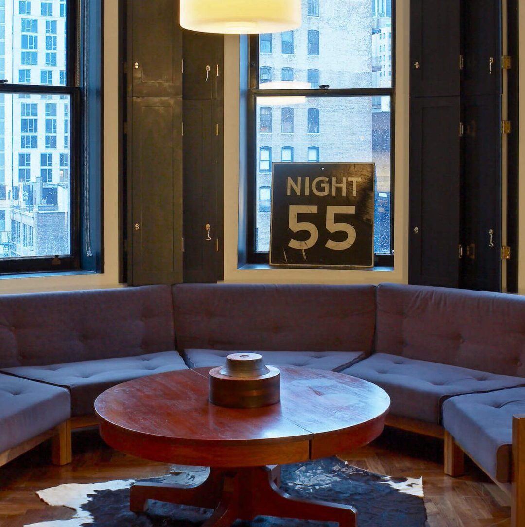 Loft Suite living area with corner views of Manhattan at Ace Hotel New York