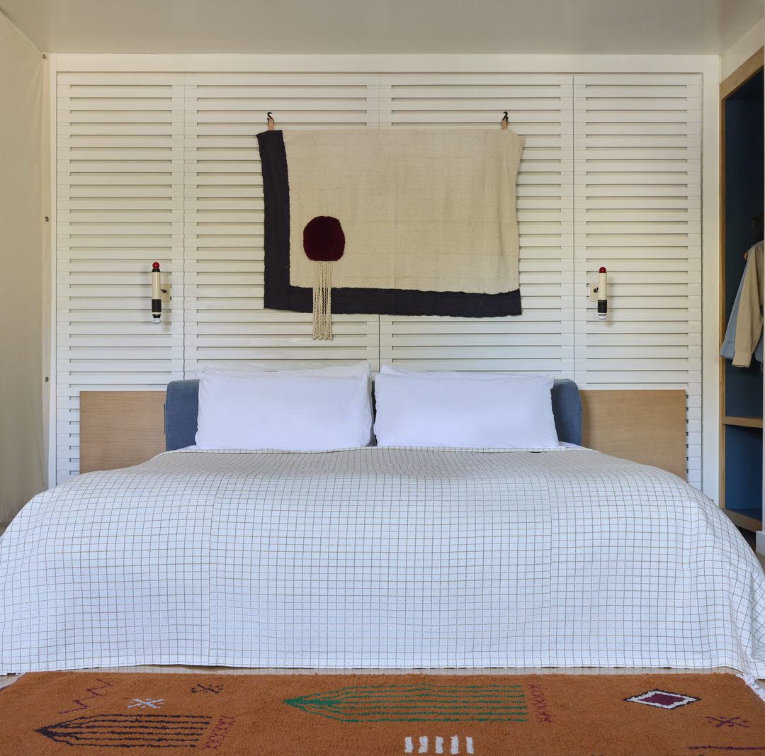 spacious king bed is adorned by wall-mounted night lights