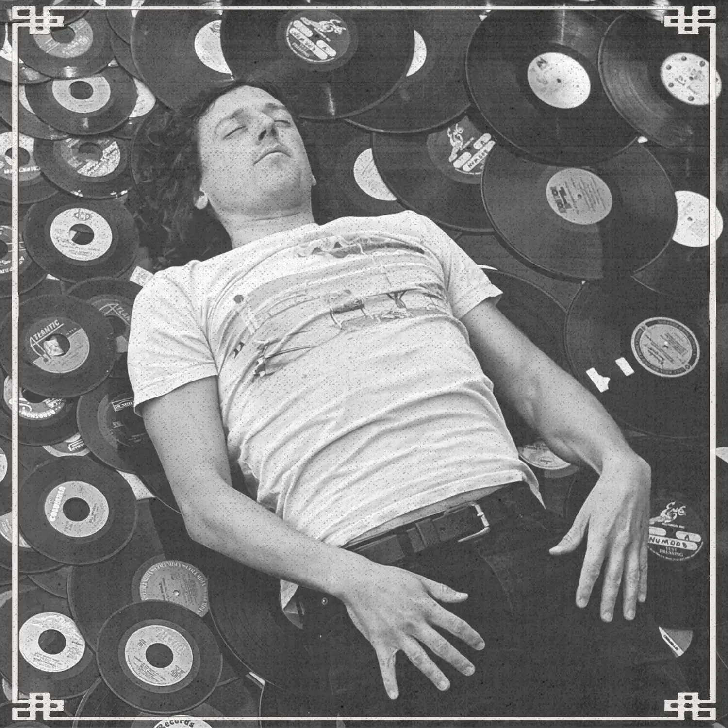 DJ Adam Lucky laying on vinyl records