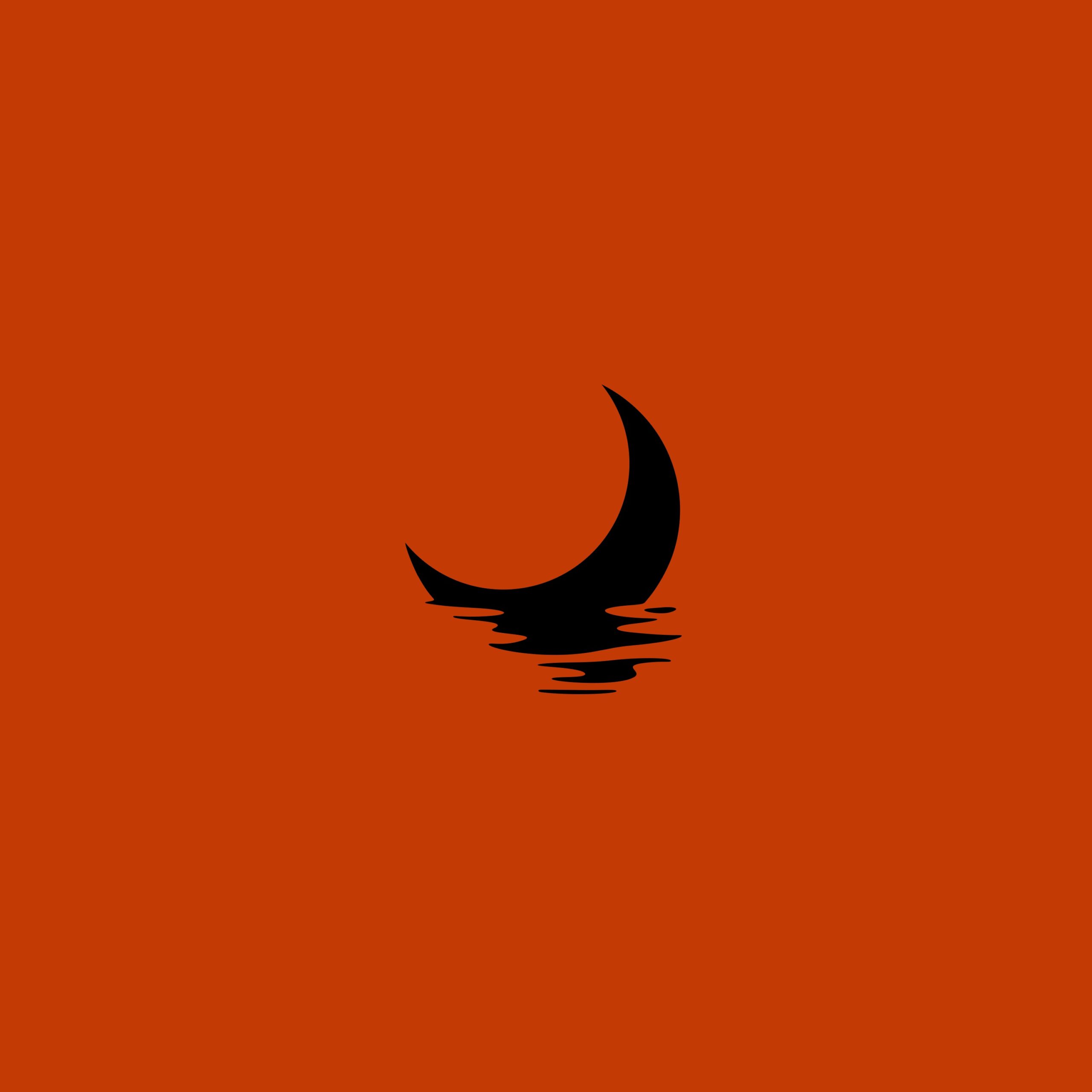 black cresent moon on rust colored backdrop