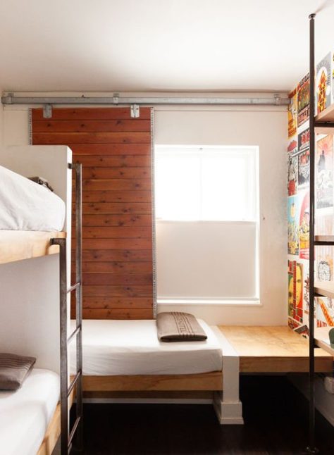 a hotel room with three beds and a TV