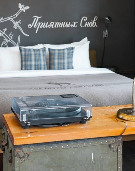 A hotel room with a bed and desk