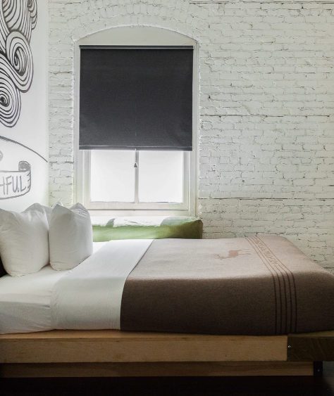 Room facing window and bed