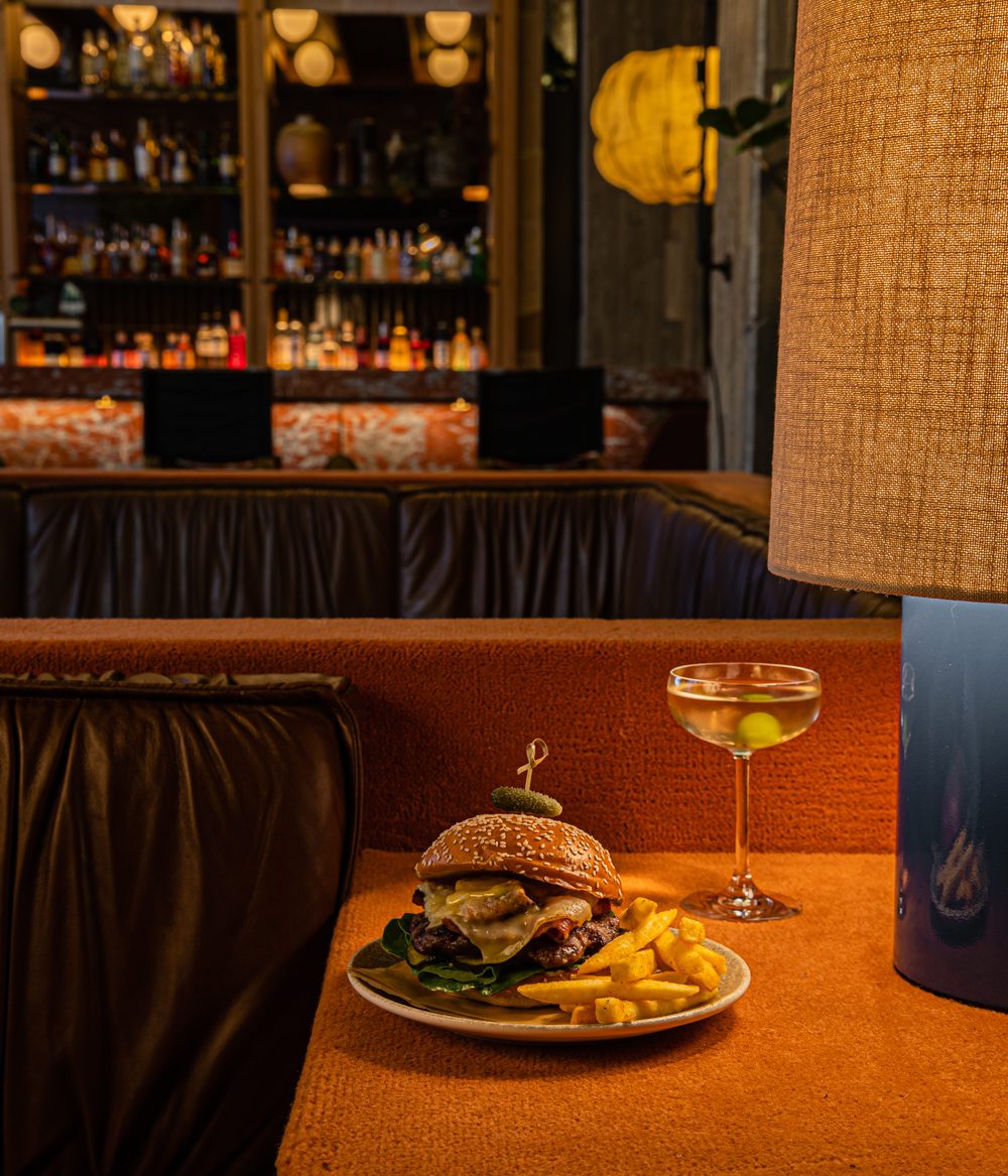 Photo of a martini and hamburger in a gorgeous lobby