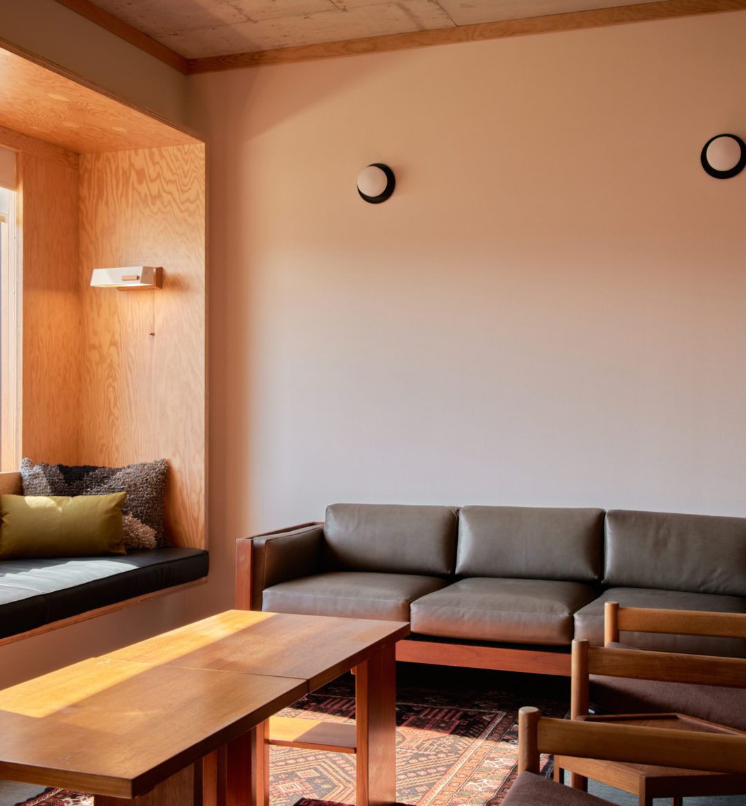 A modern black couch, black leather nook and two armchairs provide ample seating space