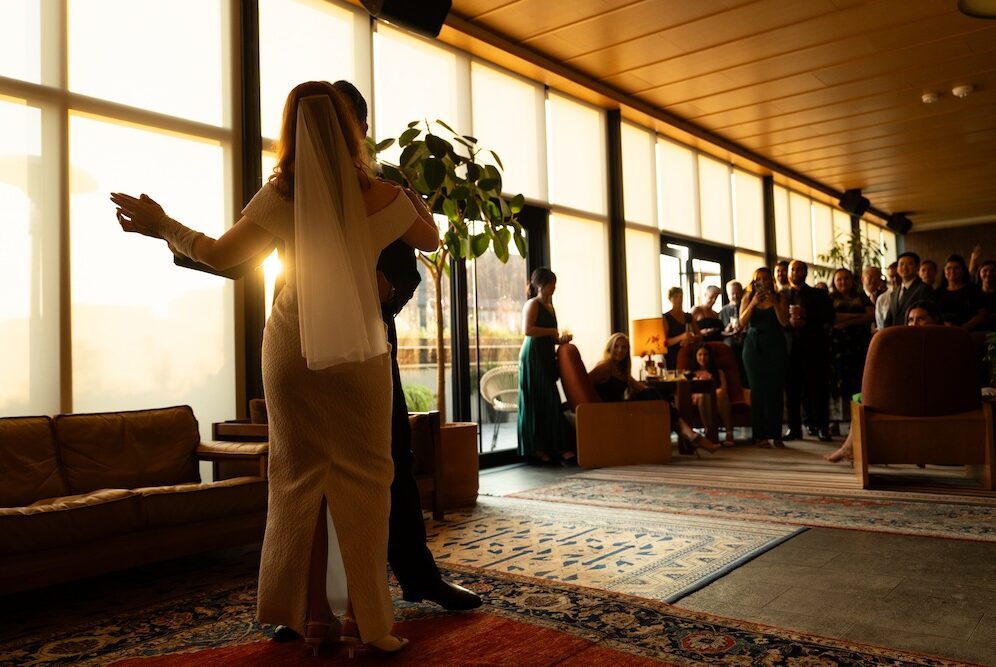 Evangeline - a bride and groom dancing while the sun is setting
