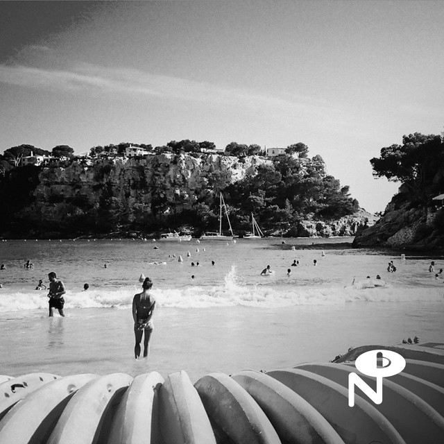 beach with people swimming in black and white