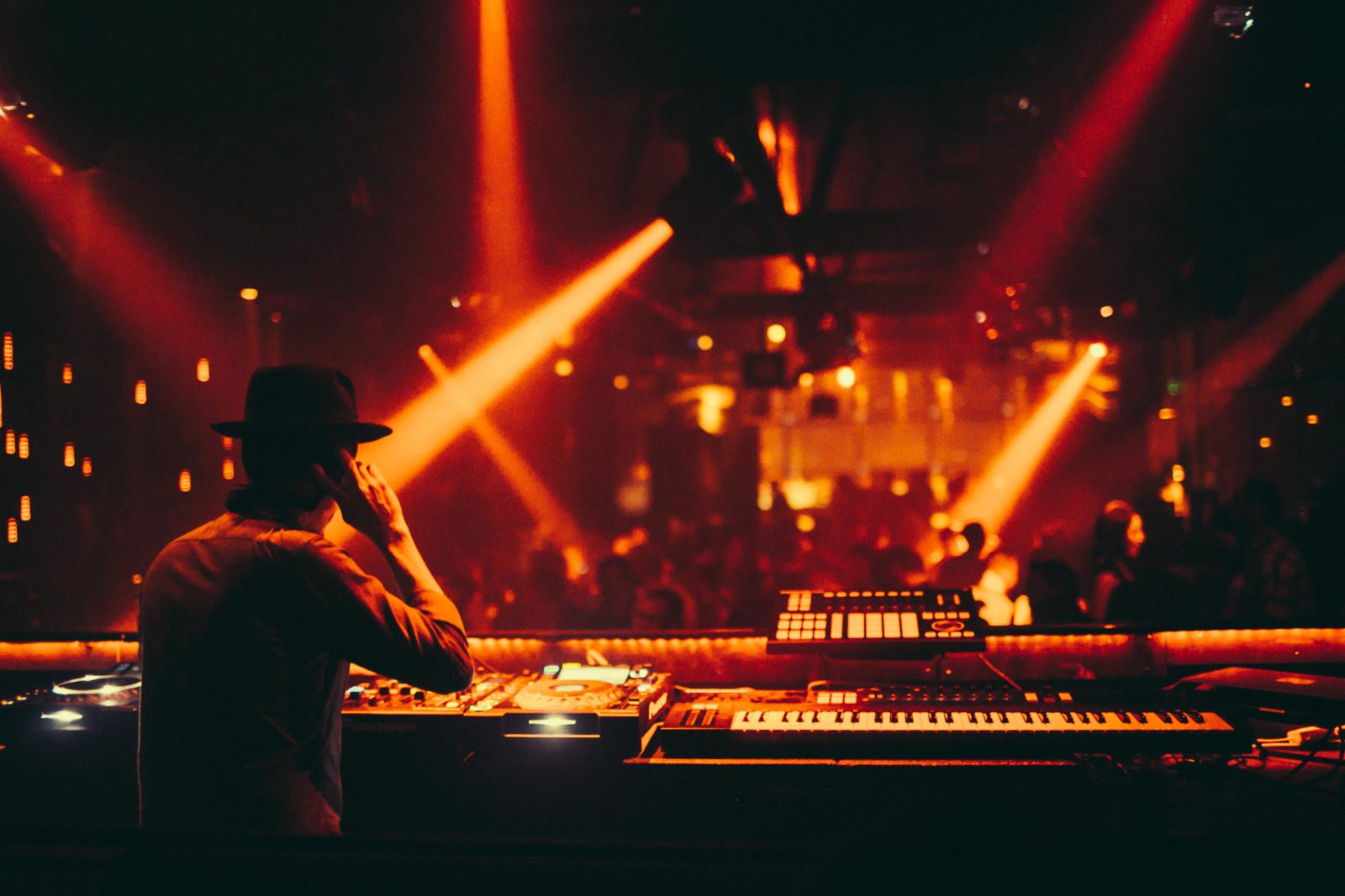DJ performing for crowd in dark room