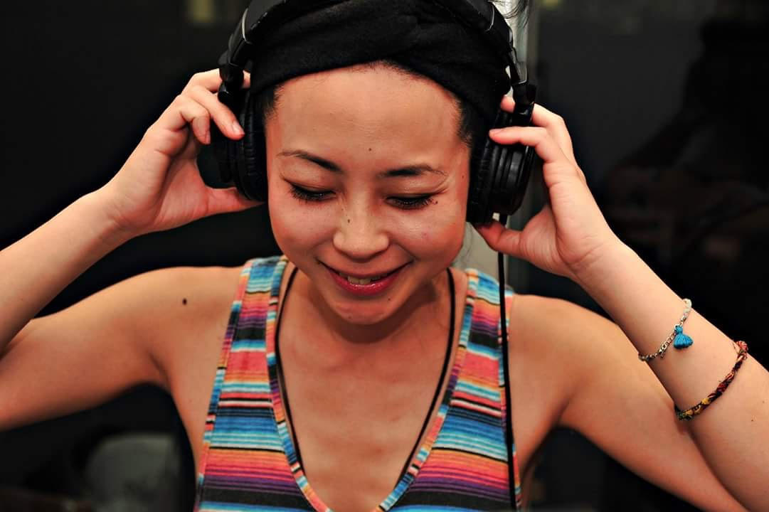 person in colorful top wearing headphones