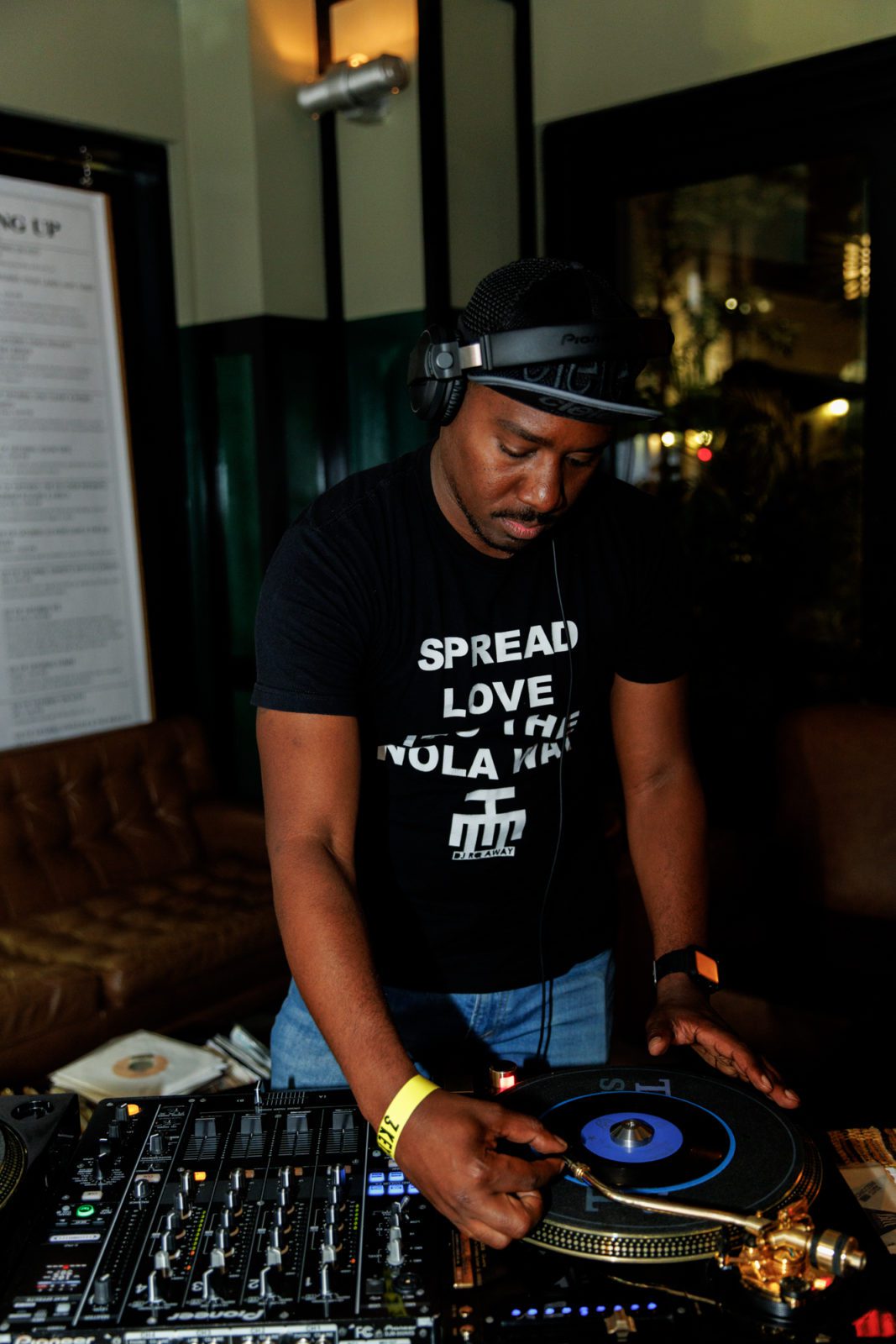 person wearing headset spinning on turntables