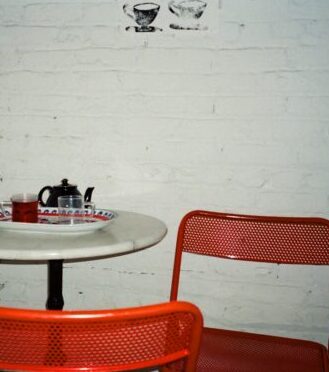 table with 2 red chairs