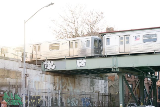 Two subway trains crossing the bridge in Brooklyn